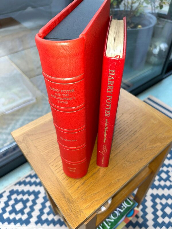 The leather-bound volume beside a standard hardback